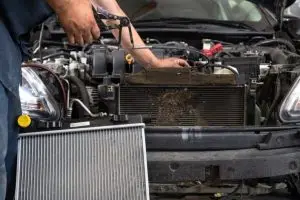 mobile mechanic installing a new radiator